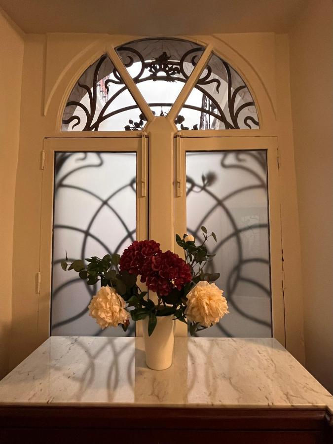a vase of flowers sits on a table in front of a window