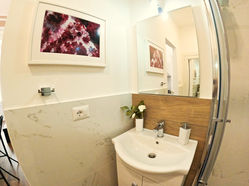 a bathroom with a sink and a picture on the wall above it