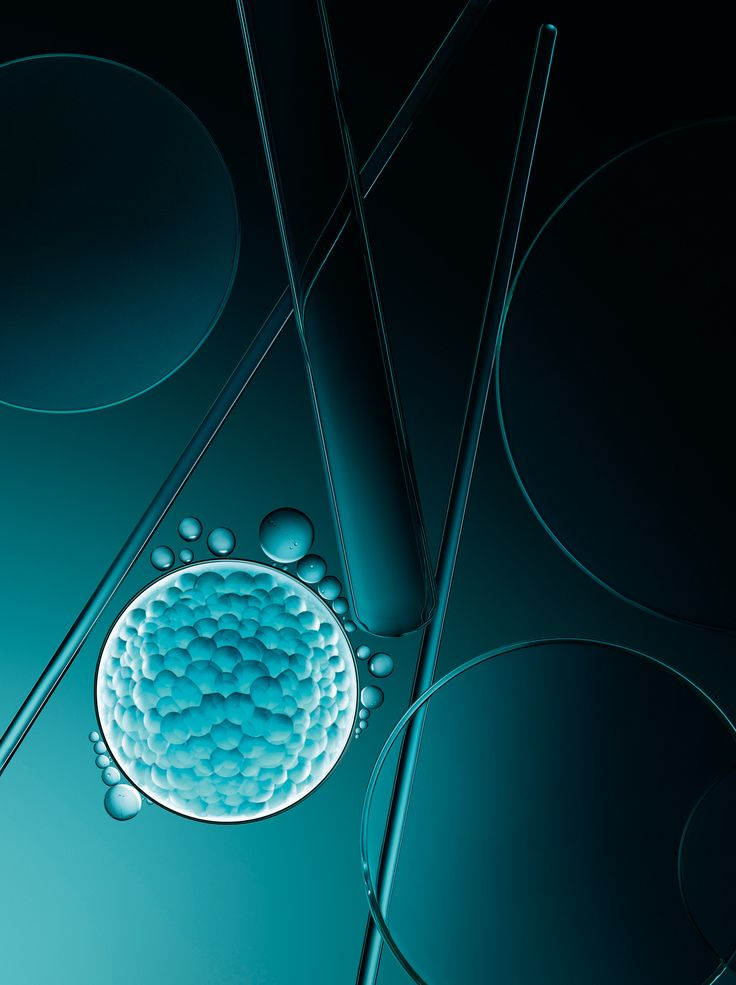 Abstract image of teal bubbles and test tubes on a dark background, creating a scientific and futuristic mood. No visible text.
