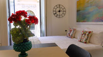 a bedroom with a bed and a clock on the wall