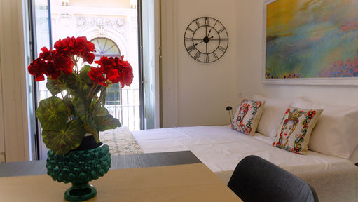 a bedroom with a bed and a clock on the wall