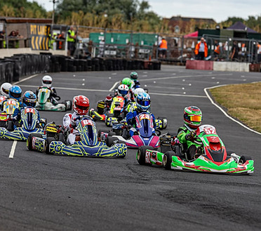 Rotax karts racing on a track.