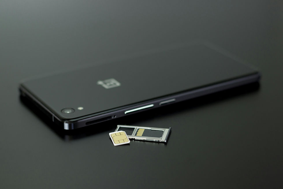 SIM card removed from smartphone tray representing SIM swap scam fraud that allows criminals to hijack your phone number and access your bank accounts