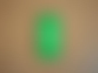 smartphone displaying WhatsApp logo on a wooden surface representing the new disappearing messages after reading privacy feature coming to iOS and Android in 2026