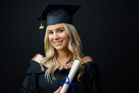 Laura University Grad Studio  Portrait holding diploma - Black Backdrop
