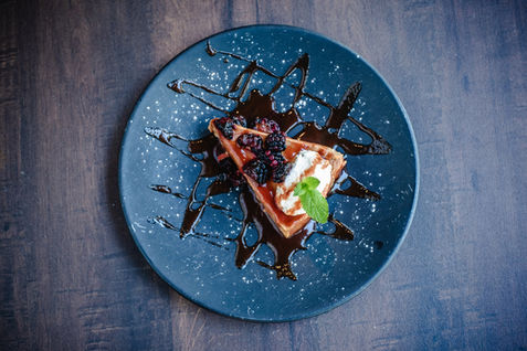 blackberry dessert served on a blue plate