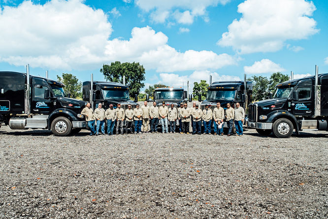 Ziron Environmental Trucking team standing by fleet of trucks