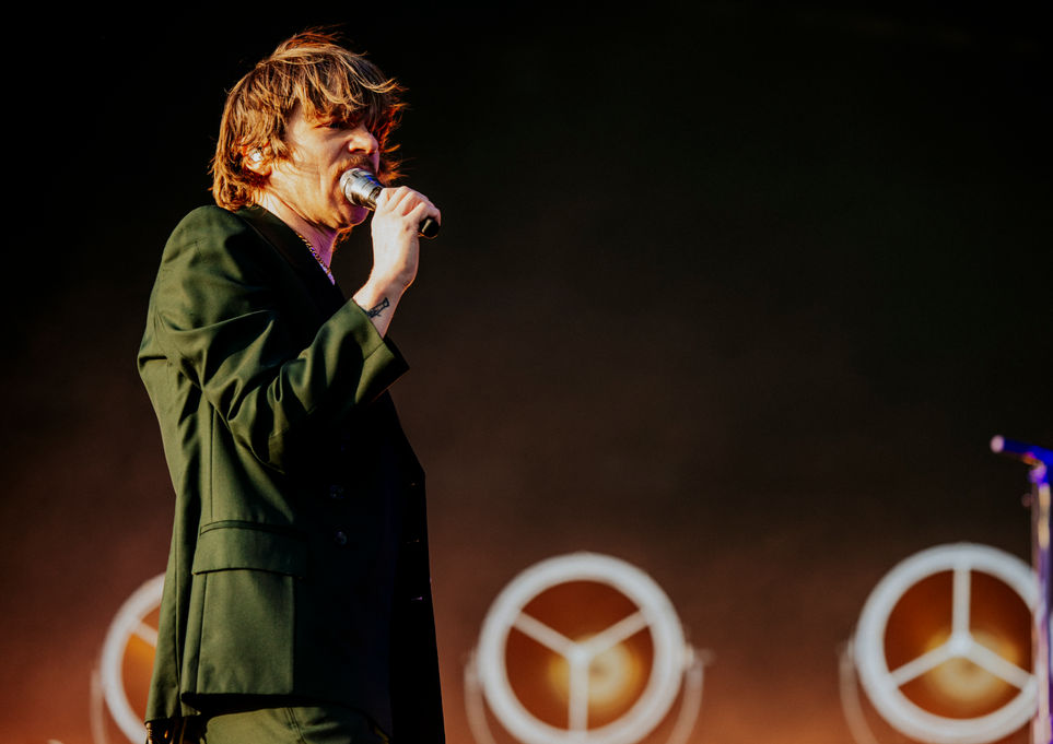 Cage the Elephant performing live, wide stage shot with dramatic lighting by Maxwell Thomason