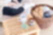 Person with notebook, mug, candle, and laundry basket