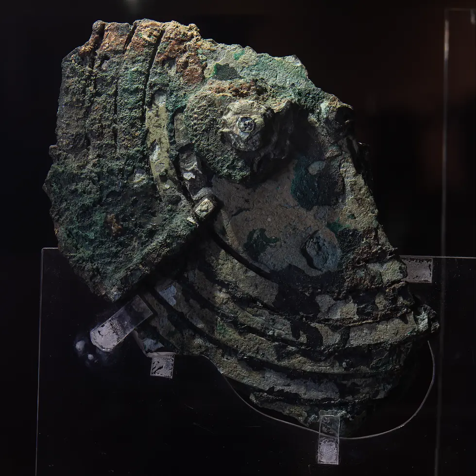 Fragment B of the Antikythera Mechanism. Part of the scale is visible, as well as a gear shaft. Image via Wikimedia Commons.