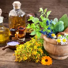 Ayurvedic herbal oil bottle with leaves and traditional wellness setup