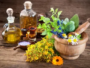 Ayurvedic herbal oil bottle with leaves and traditional wellness setup