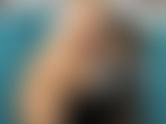 a woman looking under the sink struggling with a blocked drain calling a drainage engineer