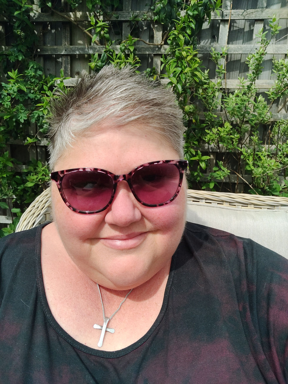 A photo of me in the garden wearing my dark glasses and a black dress