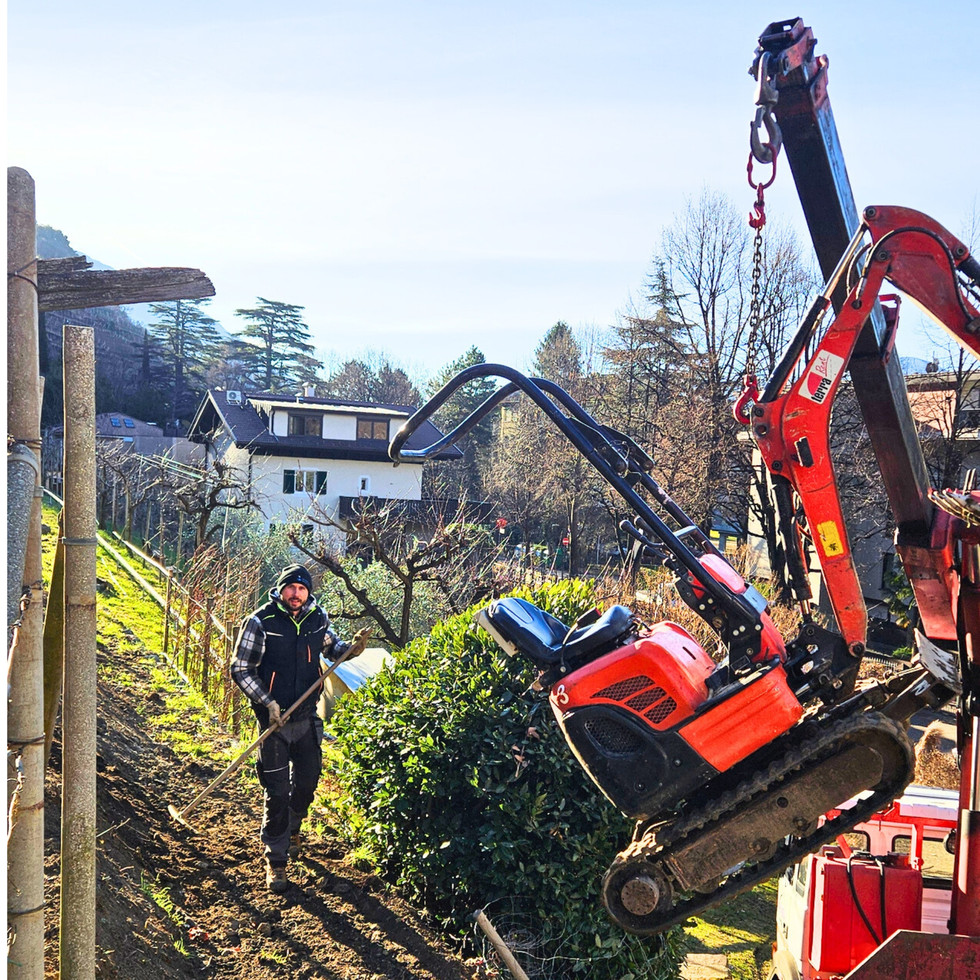 Bagger wird mit Kran auf den LKW gehoben