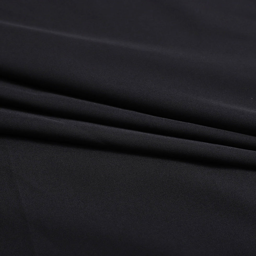 Close-up of black fabric with visible folds; Bottom Wear Fabric; texture.