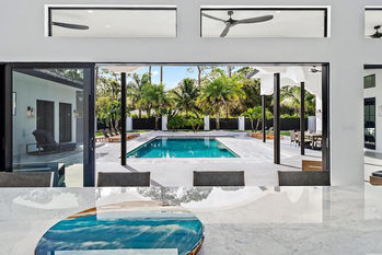 Voyage country house kitchen looks out onto pool area