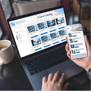 Person on computer and holding phone, both devices show the Benefitfocus University course catalog within the learning management system