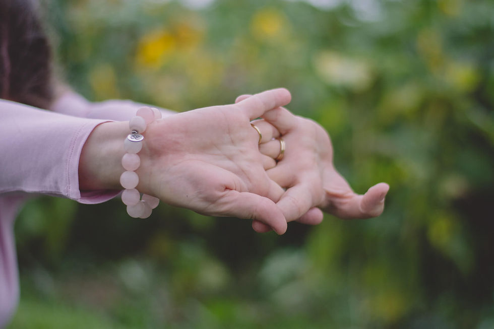 woman stretching hands rose quartz bracelet