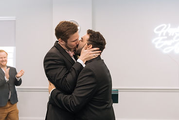 Joe and Fran kissing each other at the end of their civil partnership ceremony in St Georges' Town Hall in London