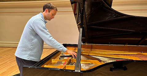 Dylan Weiss preparing concert grand in Greenville, NC