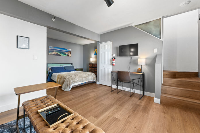 The downstairs king bedroom features an additional living room with a smart TV, workspace and ensuite bathroom. 