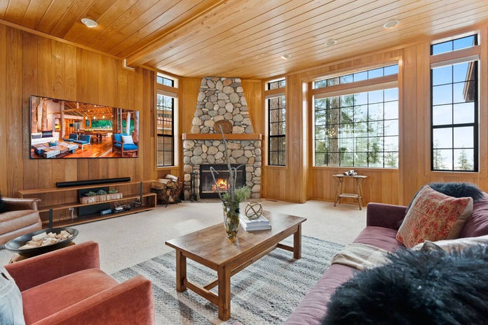 The living room with breathtaking views of Marti's Valley and a gas fireplace.