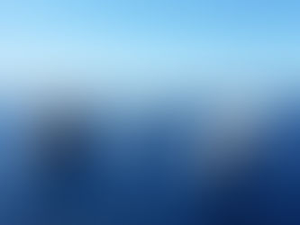 A diverse fleet of ships sails across the open sea under a clear sky, showcasing a variety of vessels from cargo ships to yachts navigating through deep blue waters.