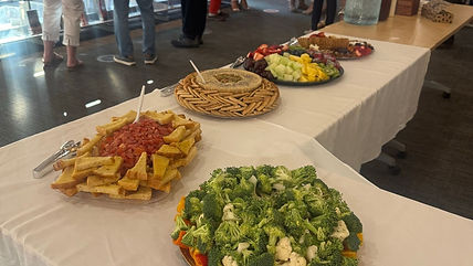 buffet table with fresh vegetables and snacks