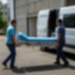 two men carrying hospital bed to van