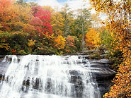 Scenic waterfall surrounded by colorful fall foliage in Highlands, North Carolina