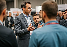 man standing in front of the crowd for a speech