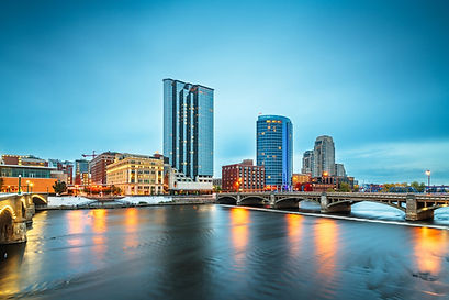 cityscape with view of river and bridge in grand rapids