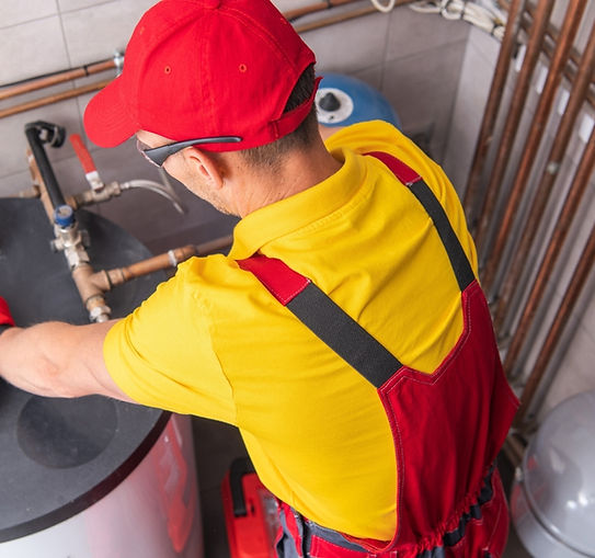 plumber fixing the water heater tank