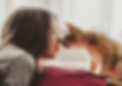 Woman on bed with cat after giving a home remedy from Peacock Pet Cafe to animal