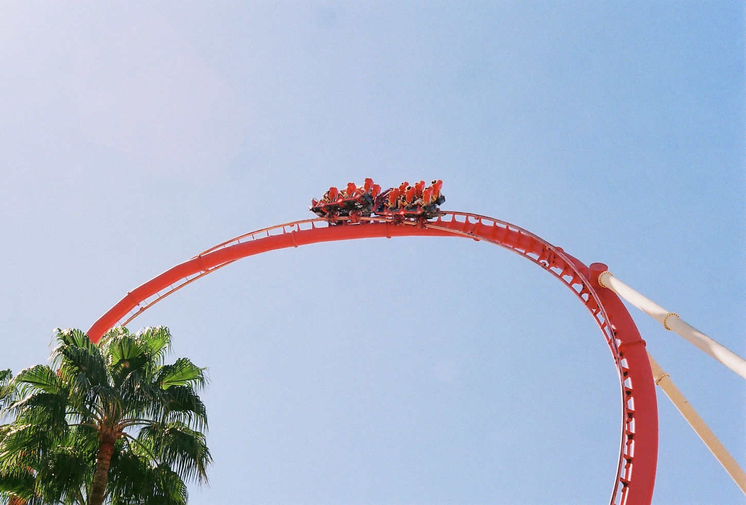 Hollywood Rip Ride Rockit at the top of the first loop in front of a blue sky