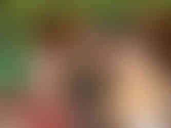 A women, man and their daughter standing in front of an unfinished wall of a house