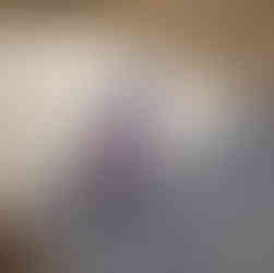 Young girl holding a hammer wearing a fox beanie and pink coat