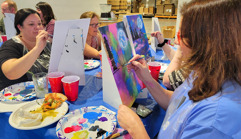 Eye-level view of a cozy paint and sip studio with easels and colorful paintings