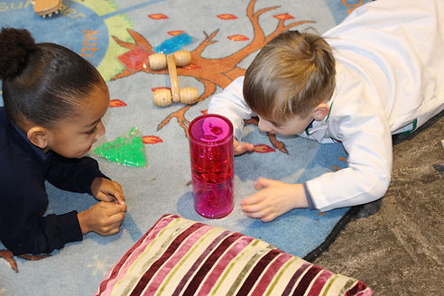 2 children playing on activity mat