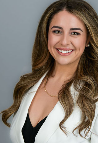 Studio Headshot of a woman on a light gray Background