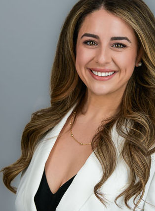 Studio Headshot of a woman on a light gray Background