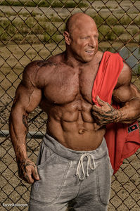 Male fitness model showing upper body muscles in On location by Tampa fitness photographer.