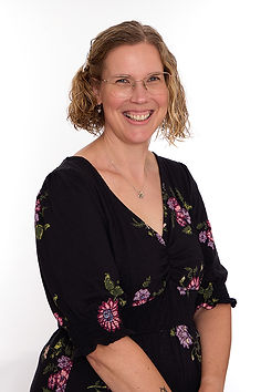 Warm, professional photograph of Anouska Wheeler and smiling at the camera.