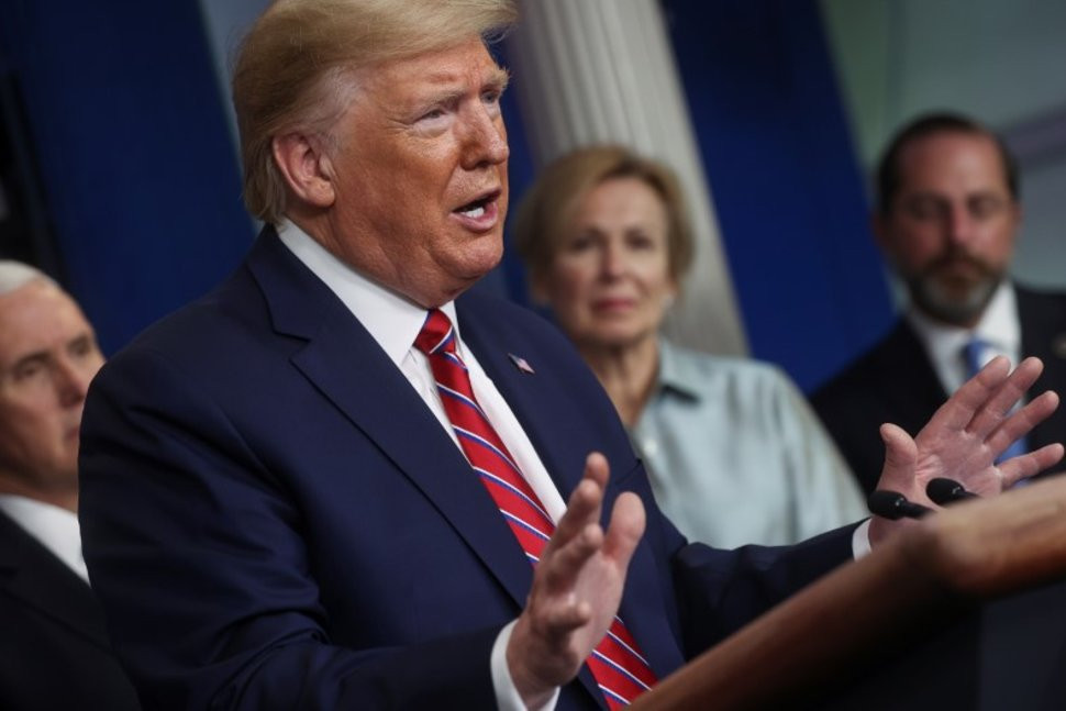 Former US President Donald Trump speaking in front of Vice President Mike Pence and two others
