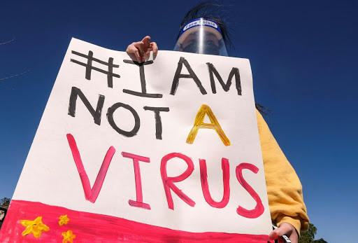 Sign reads "#I Am Not A Virus" over artwork similar to the Chinese flag