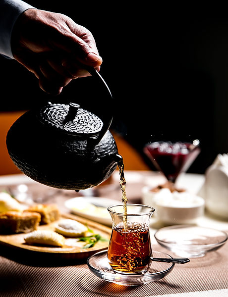 man-pouring-black-tea-armudy-national-glass-side-view copy.jpg