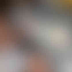 Young man woking on a copper ring at a jewelers bench