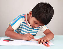 young boy drawing with pencils.jpg