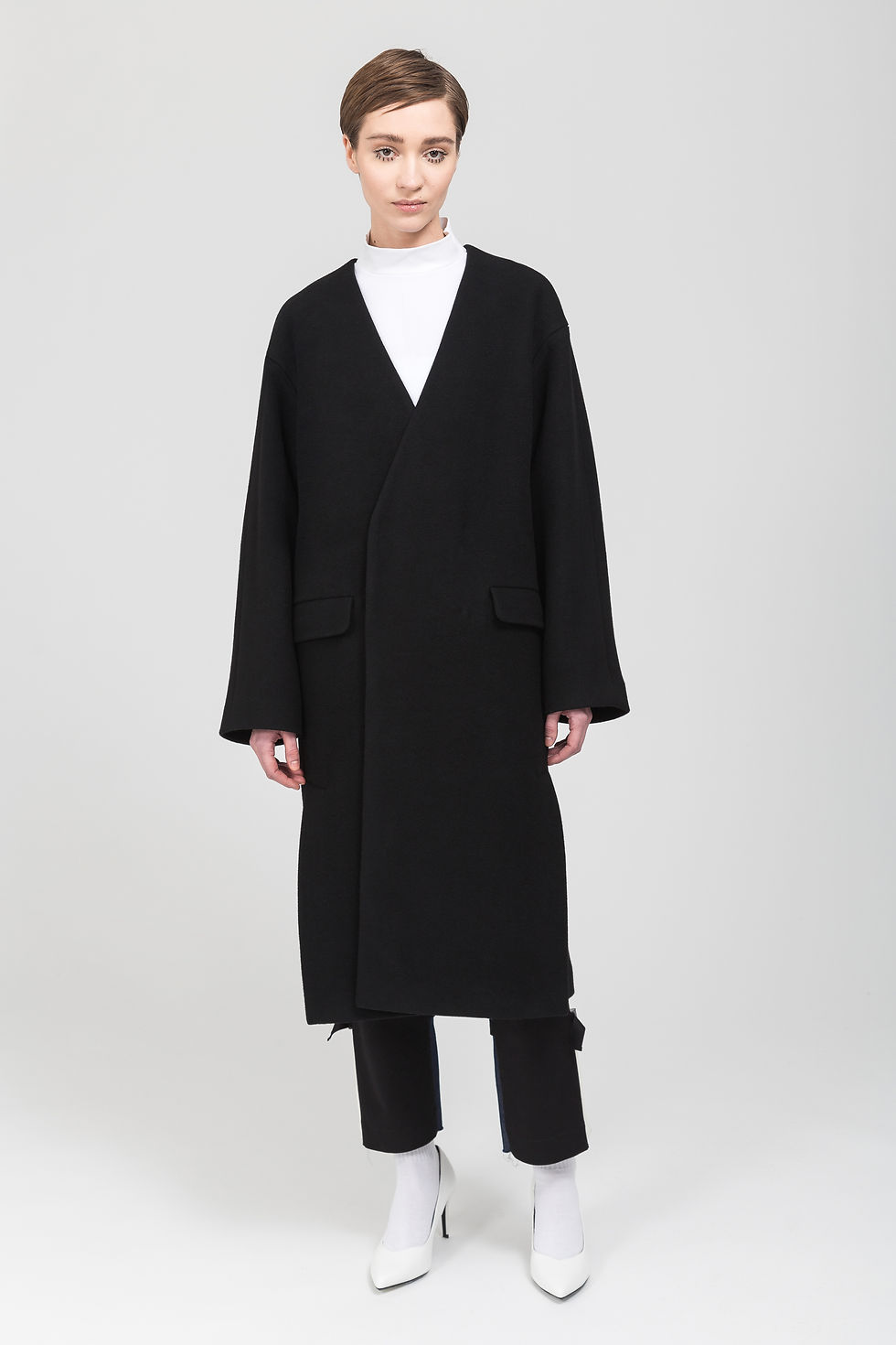 Collarless double-breasted wool coat.